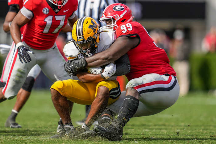 Nov 6, 2021; Athens, Georgia, USA; Georgia Bulldogs defensive lineman Jordan Davis (99) tackles Missouri Tigers running back Tyler Badie (1) during the second half at Sanford Stadium. Mandatory Credit: Dale Zanine-USA TODAY Sports